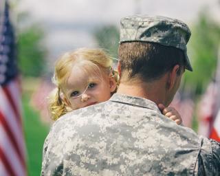 Veteran holding his daughter