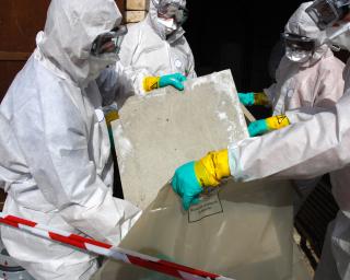 Workers removing asbestos. 