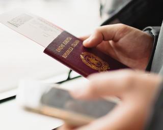 Person holding a passport and a phone
