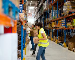 Warehouse workers are stacking goods onto the shelves