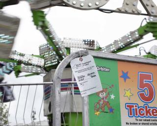 Amusement park ride with a safety inspection ticket on it