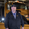 Man standing in front of a stationary snow plow